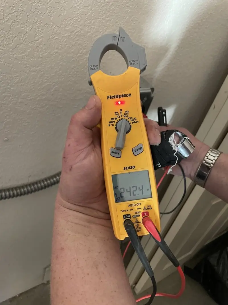 Voltage testing with clamp meter during Recessed Lighting Installation in Granger